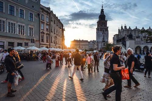 Tourists walking on a concrete street 