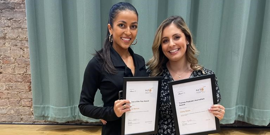 Female with dark hair tied back stands next to blonde female both holding certificates