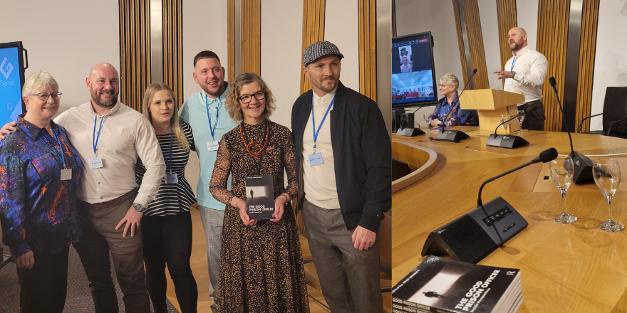 A group of people posing for a photo in a wood-panelled room.