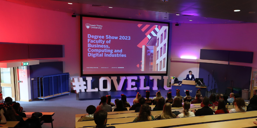 Auditorium filled with guests at event opening