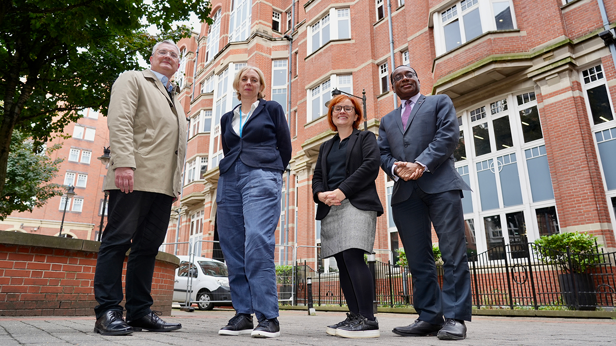 Four people outside the Leeds Trinity University City Campus.