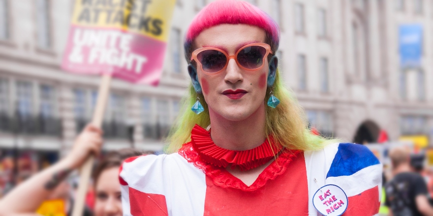 White protestor in orange clothes and sungalsses