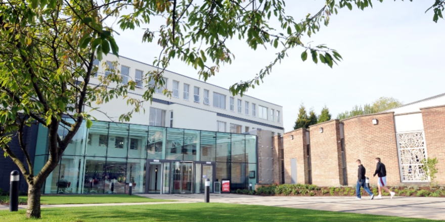 Two people entering reception, tree and grass