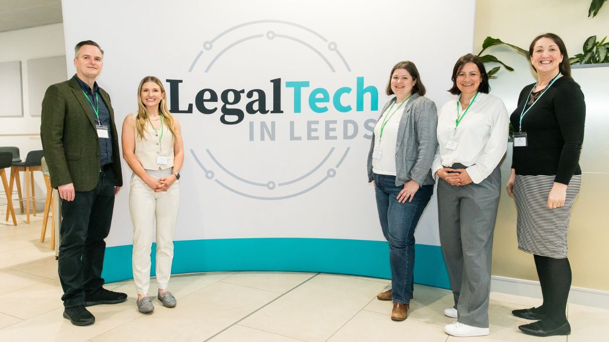 Five people stand in front of a background that says Legal Tech in Leeds