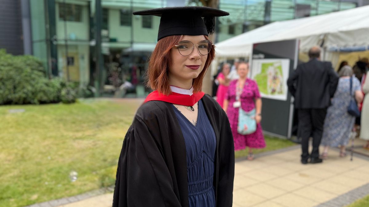 A picture of a Leeds Trinity University graduate in their cap and gown