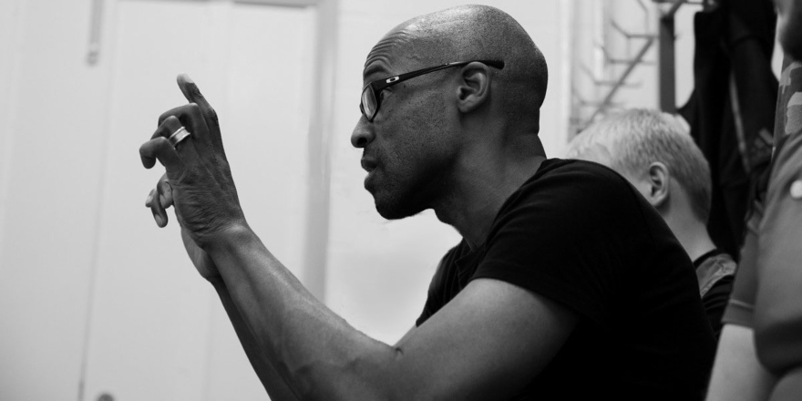 Man gesturing arms while directing