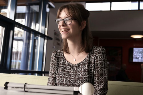 Chloe Tear sat at table with white cane